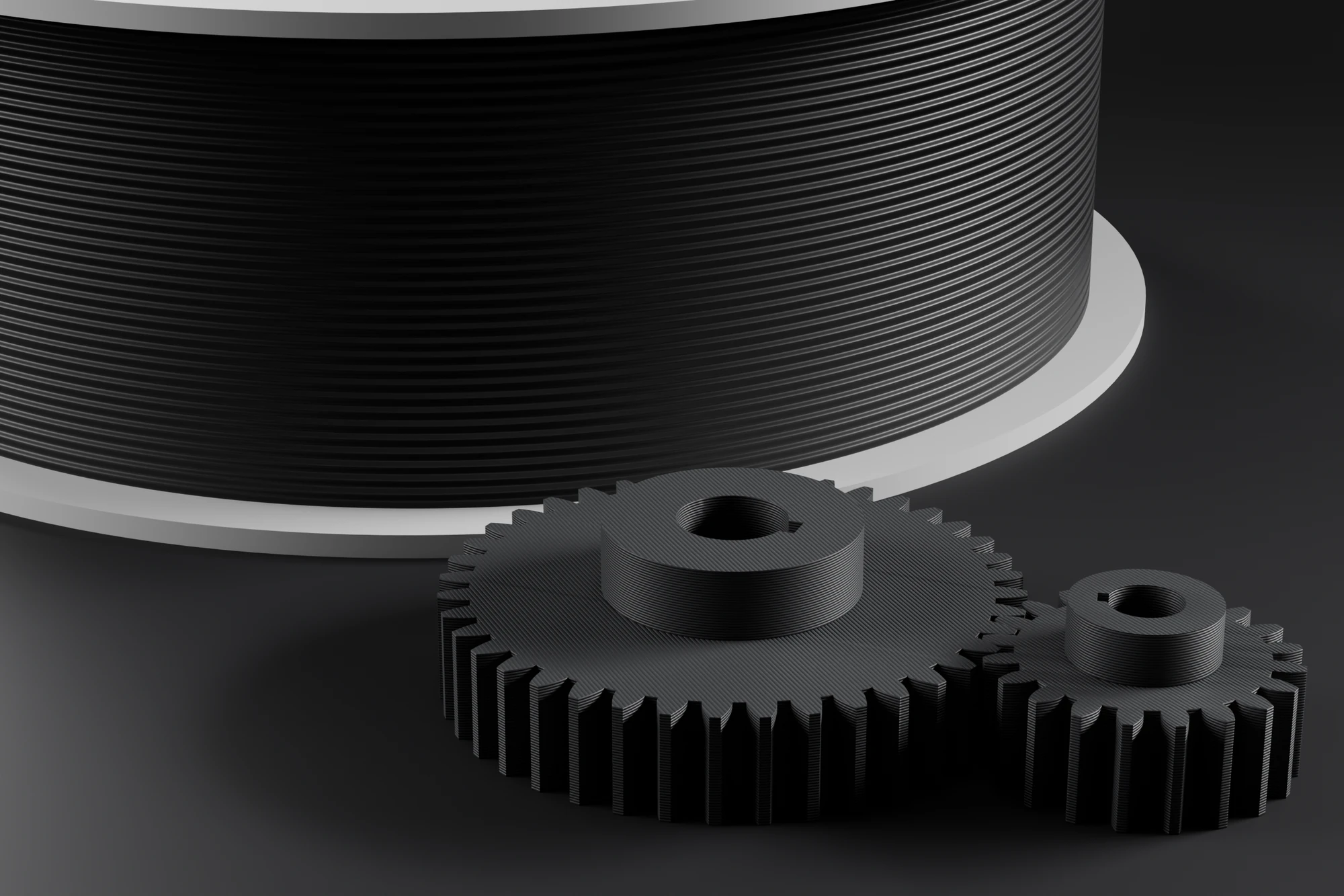 FDM printed gears in front of a spool of filament